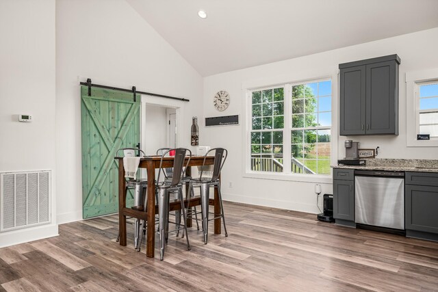 425 Royal Dr, Rock Island, TN 38581 - dining area with high vaulted ceiling, a barn door, wood finished floors, and baseboards