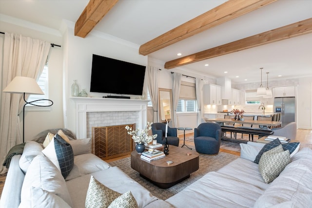 2123 Scott Ave Unit A, Nashville, TN 37216 - living room with beamed ceiling, a brick fireplace, recessed lighting, light wood-style floors, and ornamental molding