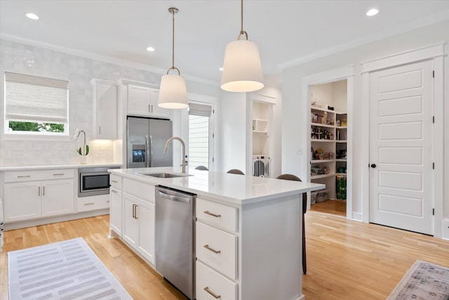 2123 Scott Ave Unit A, Nashville, TN 37216 - kitchen with appliances with stainless steel finishes, light wood-style flooring, backsplash, hanging light fixtures, and an island with sink