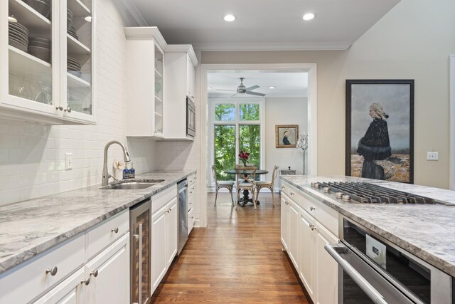 2754 Broyles Ln, Franklin, TN 37069 - kitchen with a sink, stainless steel appliances, wine cooler, crown molding, and tasteful backsplash