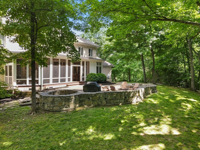 2754 Broyles Ln, Franklin, TN 37069 - view of grassy yard featuring an outdoor fire pit, a sunroom, and a patio area