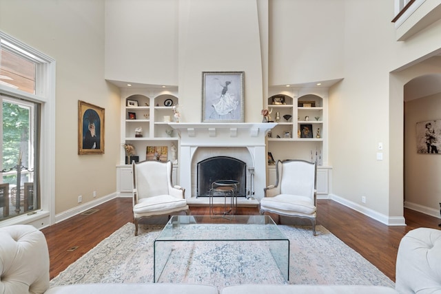 2754 Broyles Ln, Franklin, TN 37069 - living room with a towering ceiling, baseboards, wood finished floors, and built in features