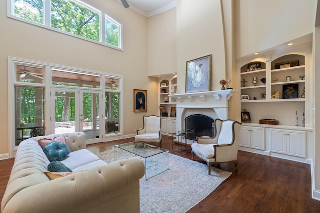 2754 Broyles Ln, Franklin, TN 37069 - living area featuring ornamental molding, built in shelves, baseboards, a fireplace, and a ceiling fan