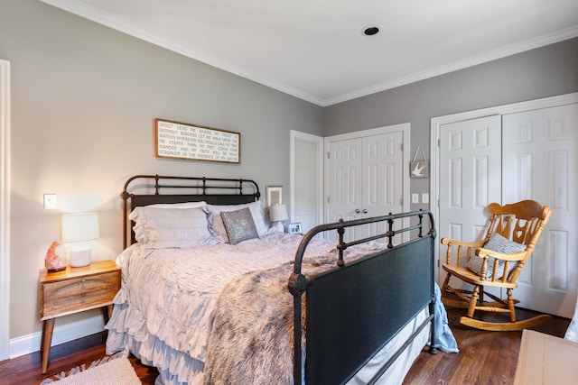 2754 Broyles Ln, Franklin, TN 37069 - bedroom featuring dark wood finished floors, two closets, crown molding, and baseboards