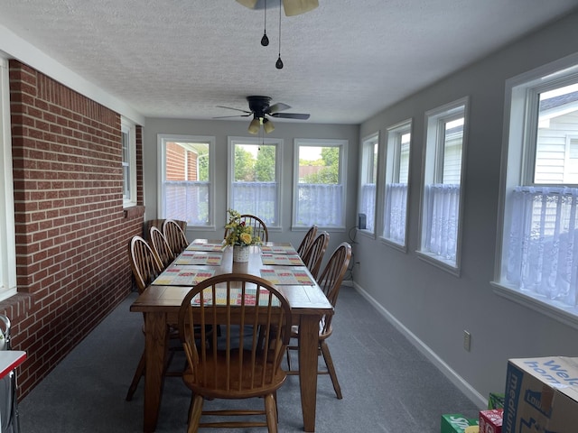 1700 Ellington Dr, Lafayette, TN 37083 - dining area with a ceiling fan, a textured ceiling, dark colored carpet, and brick wall