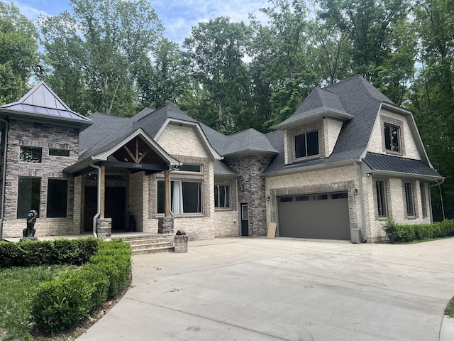 1288 Rogues Fork Rd, Bethpage, TN 37022 - view of front of property with driveway, a garage, a standing seam roof, and a porch
