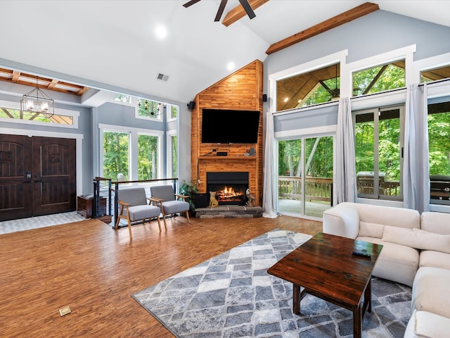 1288 Rogues Fork Rd, Bethpage, TN 37022 - living room featuring high vaulted ceiling, a fireplace, beamed ceiling, ceiling fan, and a chandelier