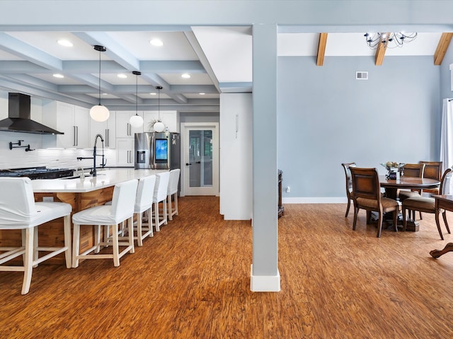 1288 Rogues Fork Rd, Bethpage, TN 37022 - kitchen with wall chimney exhaust hood, beamed ceiling, coffered ceiling, stainless steel refrigerator with ice dispenser, and dark wood-style floors