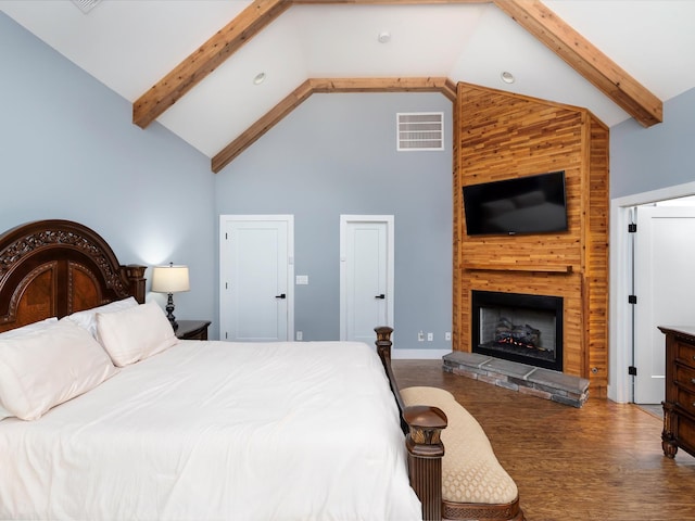 1288 Rogues Fork Rd, Bethpage, TN 37022 - bedroom featuring high vaulted ceiling, wood finished floors, beamed ceiling, and a large fireplace