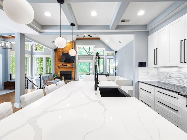 1288 Rogues Fork Rd, Bethpage, TN 37022 - kitchen featuring open floor plan, a large fireplace, white cabinets, hanging light fixtures, and recessed lighting