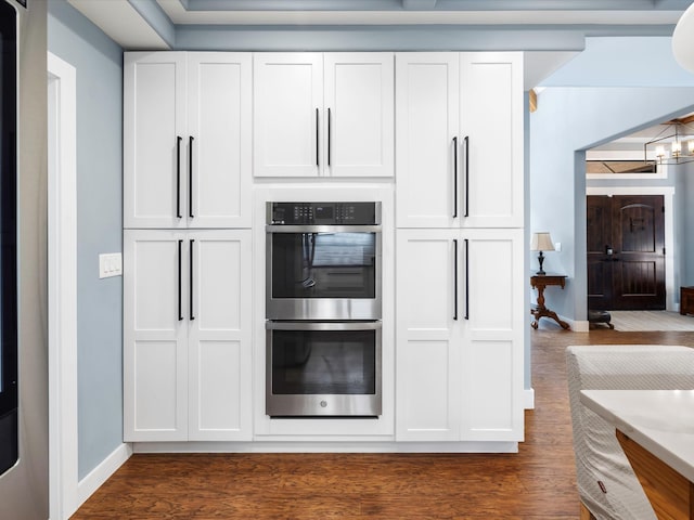 1288 Rogues Fork Rd, Bethpage, TN 37022 - kitchen featuring double oven, dark wood-style floors, white cabinetry, and a chandelier
