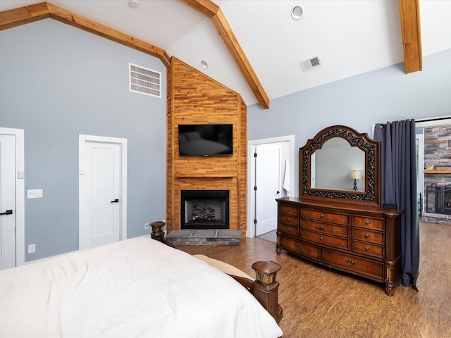 1288 Rogues Fork Rd, Bethpage, TN 37022 - bedroom featuring a large fireplace, high vaulted ceiling, wood finished floors, and beam ceiling