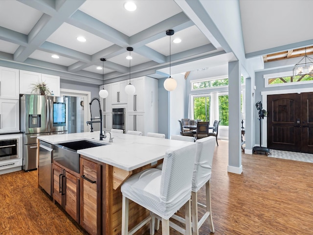 1288 Rogues Fork Rd, Bethpage, TN 37022 - kitchen with stainless steel appliances, dark wood-style flooring, white cabinetry, coffered ceiling, and a kitchen island with sink