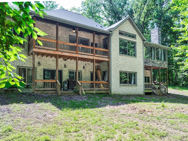 1288 Rogues Fork Rd, Bethpage, TN 37022 - back of property featuring ceiling fan, brick siding, a chimney, a yard, and a deck