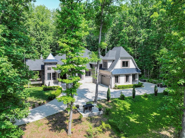 1288 Rogues Fork Rd, Bethpage, TN 37022 - view of front facade featuring a standing seam roof, a metal roof, concrete driveway, a front lawn, and stone siding