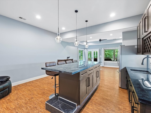 1288 Rogues Fork Rd, Bethpage, TN 37022 - kitchen with a kitchen breakfast bar, light wood-style flooring, a center island, recessed lighting, and pendant lighting