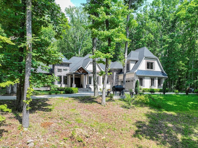 1288 Rogues Fork Rd, Bethpage, TN 37022 - view of front of home featuring a standing seam roof, a metal roof, stone siding, and a front yard