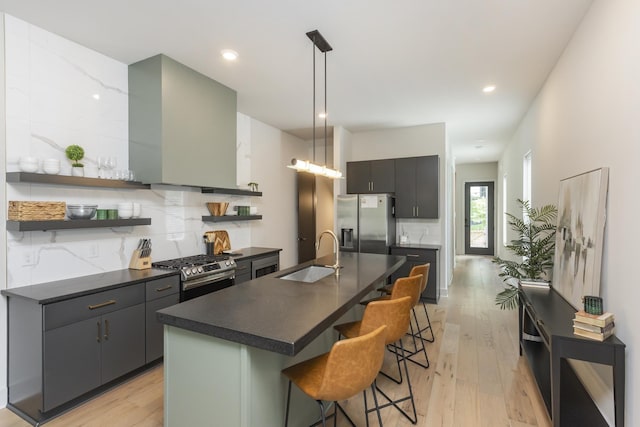 408D Moore Ave, Nashville, TN 37203 - kitchen featuring a sink, appliances with stainless steel finishes, dark countertops, wall chimney range hood, and recessed lighting