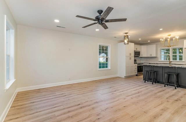 1767C W Main St, Franklin, TN 37064 - kitchen with stainless steel appliances, a chandelier, light wood-style floors, a breakfast bar area, and recessed lighting