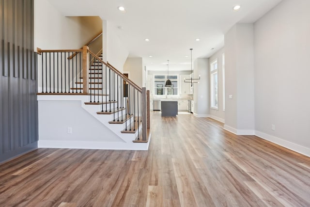 107 E 9th St Unit C5, Columbia, TN 38401 - unfurnished living room featuring light wood-style floors, stairway, baseboards, a sink, and recessed lighting