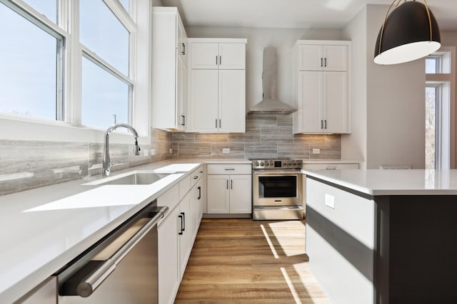 107 E 9th St Unit C5, Columbia, TN 38401 - kitchen featuring stainless steel appliances, wall chimney range hood, a sink, and light countertops