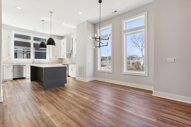 107 E 9th St Unit C5, Columbia, TN 38401 - kitchen featuring appliances with stainless steel finishes, backsplash, white cabinetry, a kitchen island, and recessed lighting