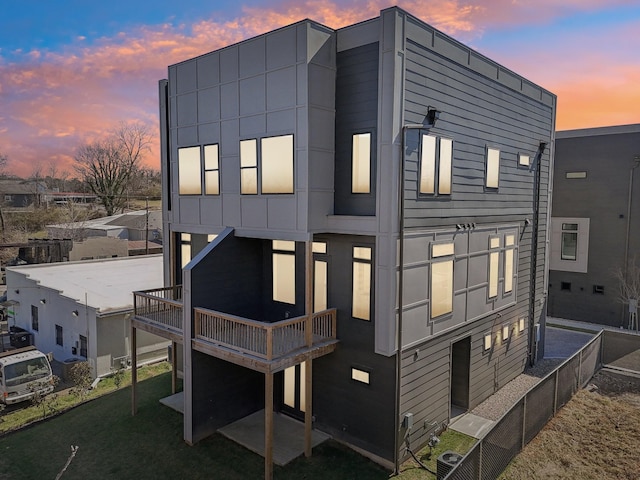 107 E 9th St Unit C5, Columbia, TN 38401 - back of house at dusk with central AC and a deck