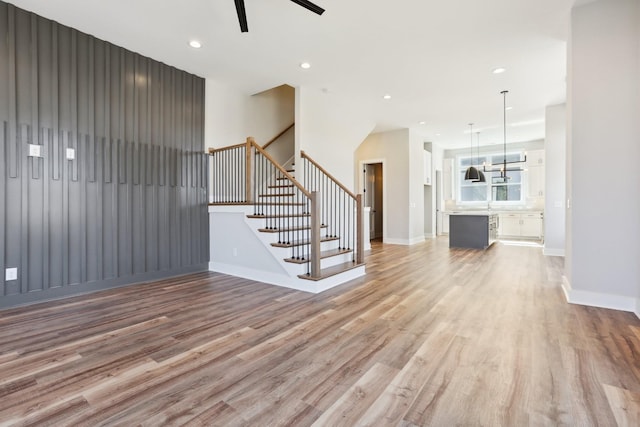 107 E 9th St Unit C5, Columbia, TN 38401 - unfurnished living room with light wood-style flooring, ceiling fan, stairs, baseboards, and recessed lighting