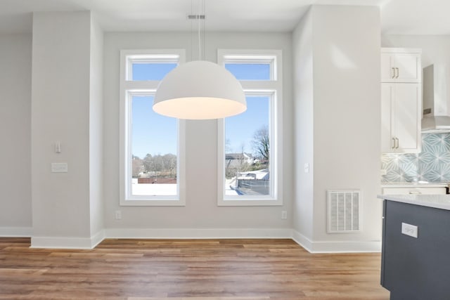 107 E 9th St Unit C6, Columbia, TN 38401 - unfurnished dining area with light wood-style floors, plenty of natural light, and baseboards