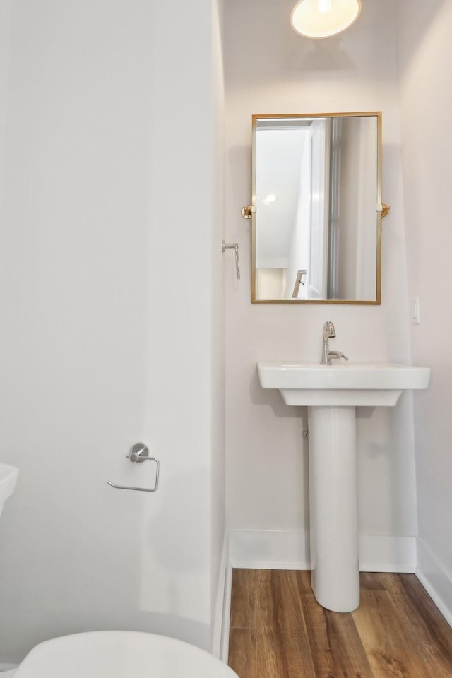 107 E 9th St Unit C6, Columbia, TN 38401 - half bathroom with wood finished floors, toilet, baseboards, and a sink