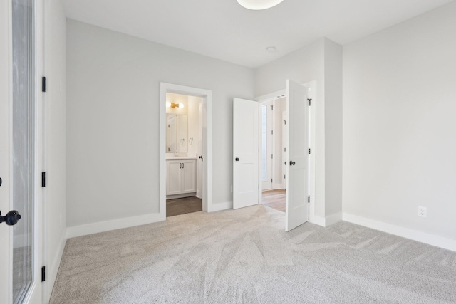 107 E 9th St Unit C6, Columbia, TN 38401 - unfurnished bedroom with carpet floors, baseboards, and connected bathroom