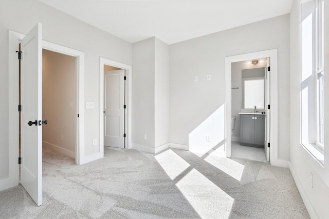 107 E 9th St Unit C6, Columbia, TN 38401 - unfurnished bedroom featuring light colored carpet, ensuite bath, and baseboards