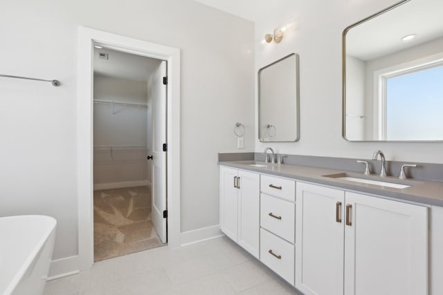 107 E 9th St Unit C6, Columbia, TN 38401 - bathroom with double vanity, a soaking tub, baseboards, and a spacious closet