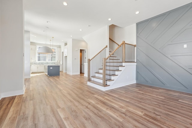 107 E 9th St Unit C6, Columbia, TN 38401 - unfurnished living room featuring light wood-type flooring, stairway, recessed lighting, and baseboards