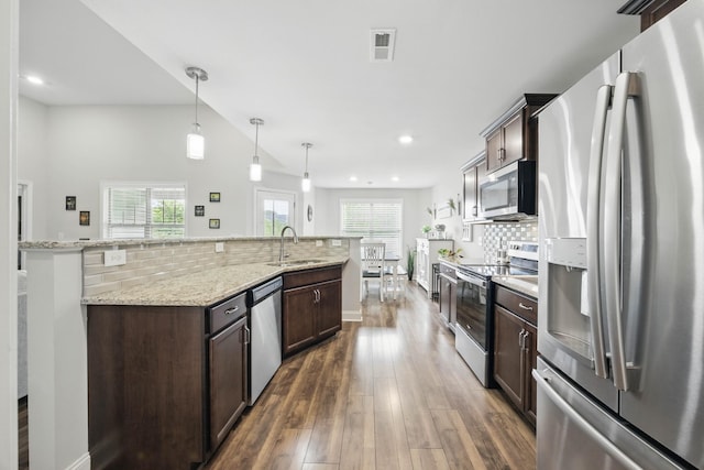 1175 Eagles Nest Ln, Clarksville, TN 37040 - kitchen with stainless steel appliances, dark brown cabinetry, backsplash, dark wood-type flooring, and recessed lighting