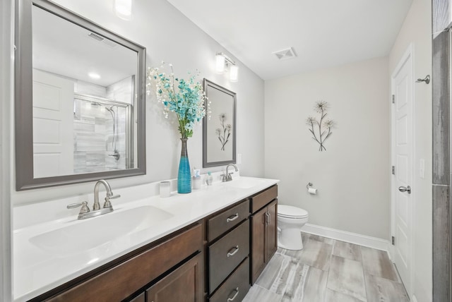 1175 Eagles Nest Ln, Clarksville, TN 37040 - bathroom with double vanity, toilet, a shower with door, and baseboards