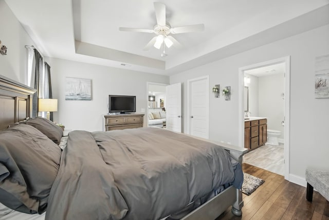 1175 Eagles Nest Ln, Clarksville, TN 37040 - bedroom with a tray ceiling, hardwood / wood-style flooring, baseboards, ensuite bathroom, and a ceiling fan