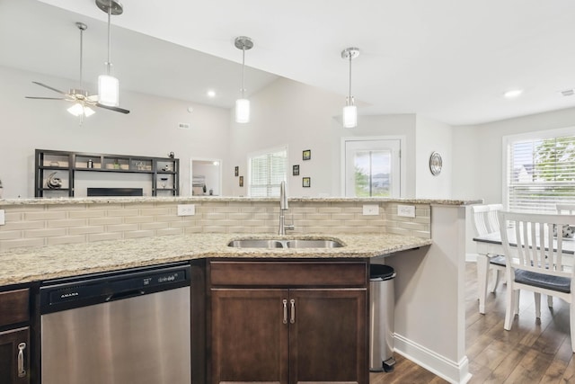 1175 Eagles Nest Ln, Clarksville, TN 37040 - kitchen with stainless steel dishwasher, a sink, dark wood-style flooring, decorative backsplash, and dark brown cabinetry