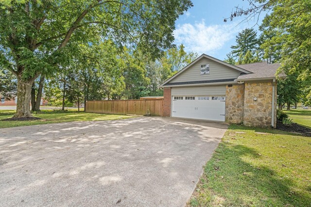 818 N Rutherford Blvd, Murfreesboro, TN 37130 - view of property exterior with driveway, an attached garage, and stone siding