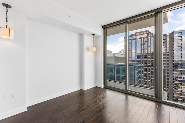 1212 Laurel St Unit 1902, Nashville, TN 37203 - spare room featuring wood finished floors, expansive windows, baseboards, and a view of city