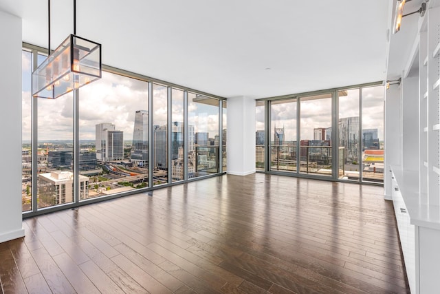 1212 Laurel St Unit 1902, Nashville, TN 37203 - spare room with a view of skyline, floor to ceiling windows, wood-type flooring, and healthy amount of natural light