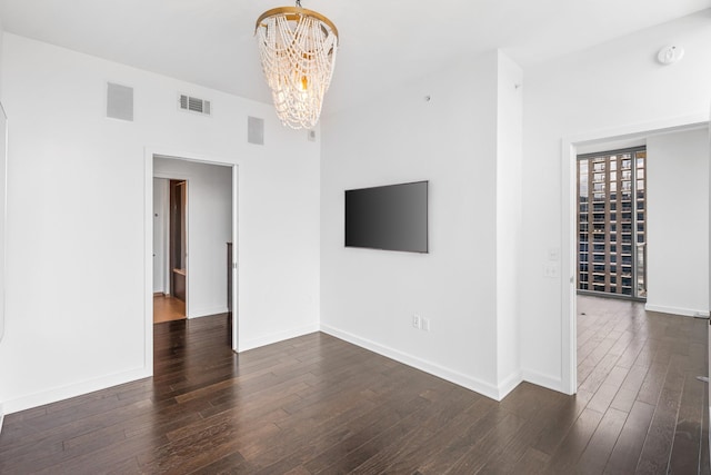 1212 Laurel St Unit 1902, Nashville, TN 37203 - unfurnished living room with a chandelier, dark wood-style flooring, and baseboards