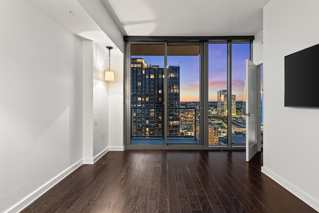 1212 Laurel St Unit 1902, Nashville, TN 37203 - empty room featuring expansive windows, hardwood / wood-style floors, and baseboards