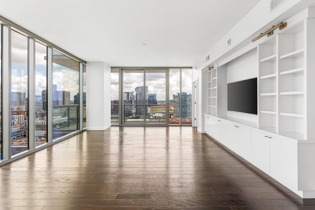 1212 Laurel St Unit 1902, Nashville, TN 37203 - unfurnished living room featuring a view of city, dark wood-style flooring, a wall of windows, and built in shelves