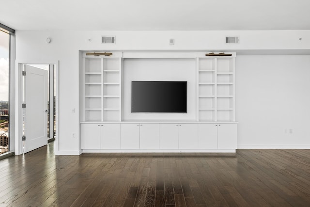 1212 Laurel St Unit 1902, Nashville, TN 37203 - unfurnished living room featuring dark wood-style floors, baseboards, and built in shelves