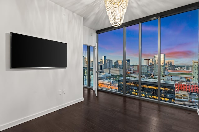 1212 Laurel St Unit 1902, Nashville, TN 37203 - unfurnished room featuring a chandelier, a view of city, hardwood / wood-style flooring, baseboards, and floor to ceiling windows