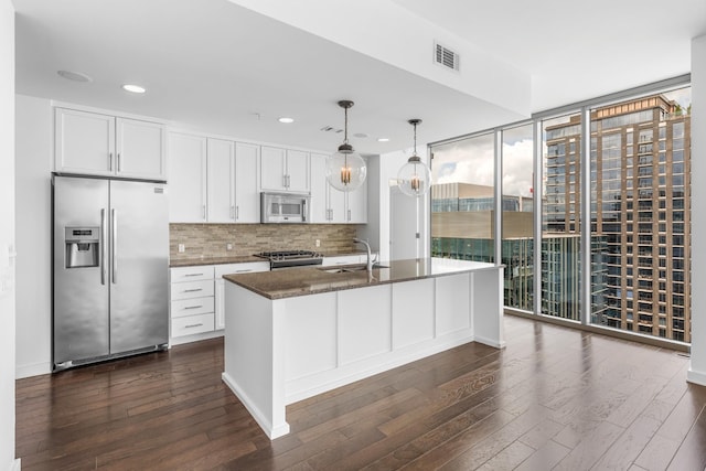 1212 Laurel St Unit 1902, Nashville, TN 37203 - kitchen featuring appliances with stainless steel finishes, expansive windows, a sink, dark wood finished floors, and backsplash
