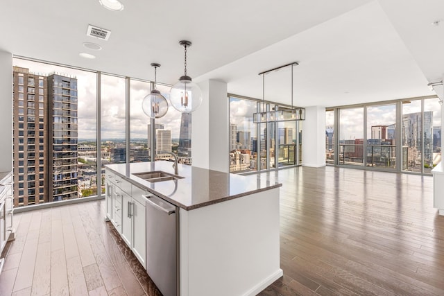 1212 Laurel St Unit 1902, Nashville, TN 37203 - kitchen with a wall of windows, a sink, dishwasher, a city view, and dark wood-type flooring
