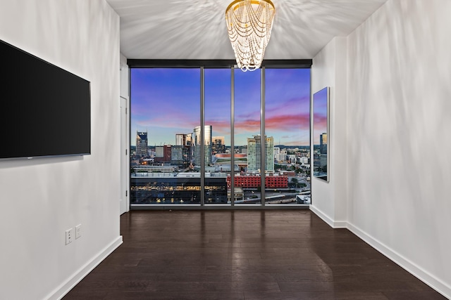 1212 Laurel St Unit 1902, Nashville, TN 37203 - unfurnished room featuring expansive windows, a chandelier, hardwood / wood-style flooring, a view of city, and baseboards