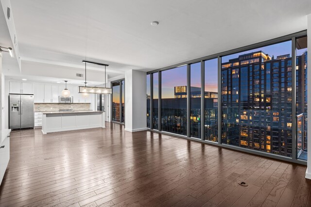1212 Laurel St Unit 1902, Nashville, TN 37203 - unfurnished living room with dark wood-style flooring, a view of city, expansive windows, and baseboards